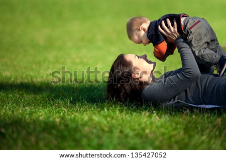 Happy Family. A Young Mother And Baby Playing