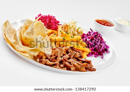 A Tasty food . Grilled meat with French fries and salad over white background. High quality image