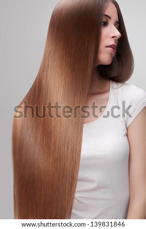 Brown Hair. Beautiful Woman with Healthy Long Hair.