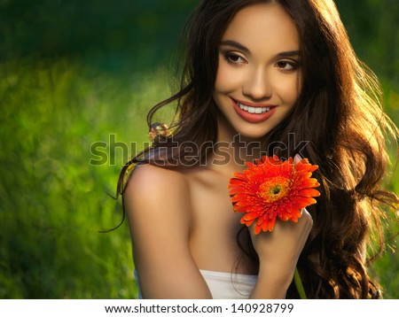 Beautiful Girl With Red Flowers. Beautiful Model Woman Face.