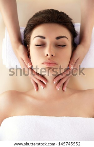 Spa Woman. Close-up of a young woman getting spa treatment. Face Massage