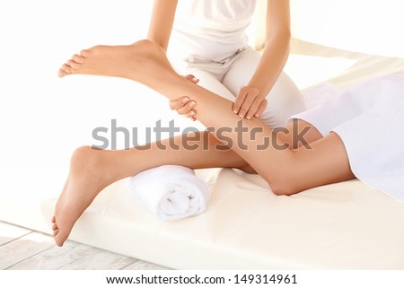 Spa Woman. Close-up of a young woman getting spa treatment. Foot massage