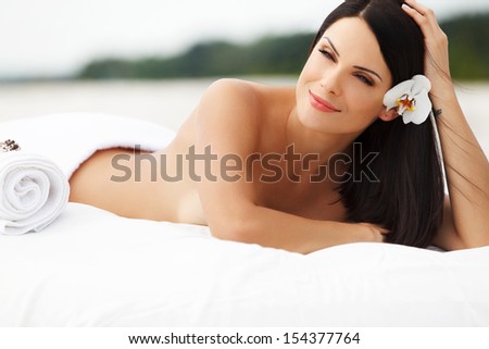 Spa Woman. Beautiful young woman relaxing after massage. Spa salon.