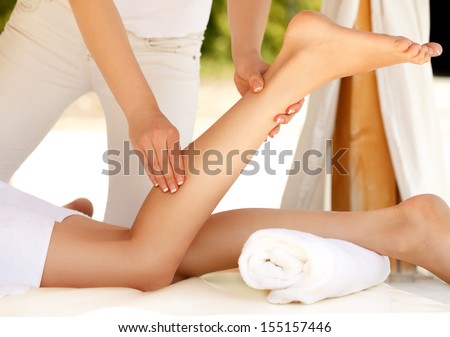 Foot Massage. Close-up of a Young Woman Getting Spa Treatment.
