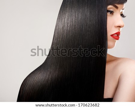 Hair. Beautiful Woman with Healthy Long Hair. Red Lips and nice Makeup. Black Hair