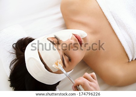 Spa Mask. Woman in Spa Salon. Face Mask. Facial Clay Mask. Treatment