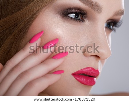 Manicure and Makeup. Beautiful Woman With Pink Nails and Luxury Makeup. Red Sexy Lips and Long Eyelashes