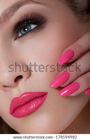 Manicure and Makeup. Beautiful Woman With Pink Nails and Luxury Makeup. Red Sexy Lips and Long Eyelashes