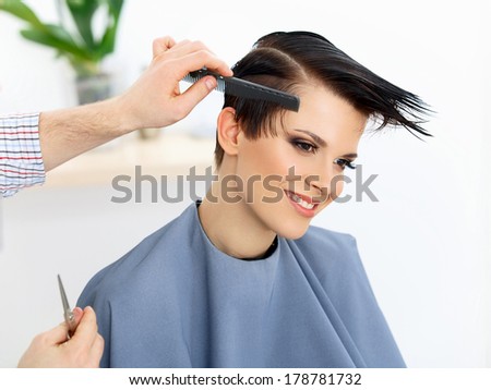 Hair. Hairdresser doing Hairstyle. Beauty Model Woman. Haircut. Hair care