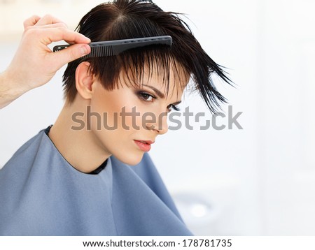 Hair. Hairdresser doing Hairstyle. Beauty Model Woman. Haircut. Hair care