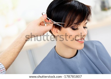 Hair. Hairdresser Cutting Woman\'s Hair in Beauty Salon. Haircut