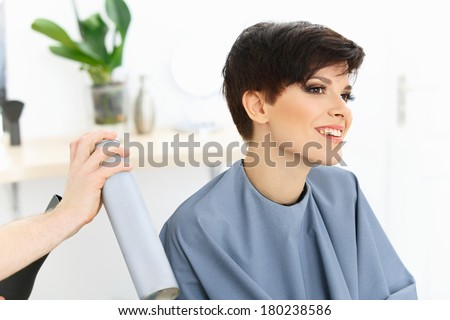 Brunette with Short Hair in Hair Salon. Hairdresser doing Hairstyle. Haircut. Hair care