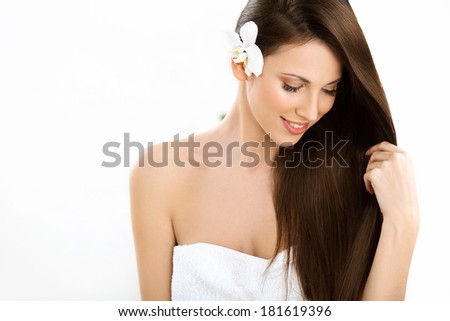 Hair. Beautifull Woman with Long Healthy and Shiny Smooth Brown Hair. Brunette Girl isolated on a white background.