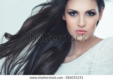 Hair. Portrait of Beautiful Woman with Black Wavy Hair. High quality image.