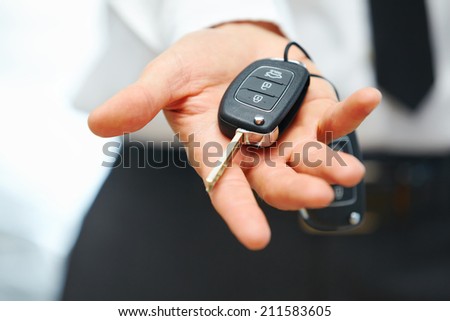 Car Keys. Seller hand giving keys