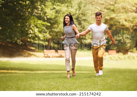 Couple in Love. Happy Couple Running in the park