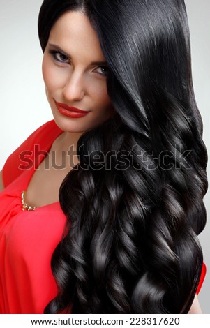 Hair. Portrait of Beautiful Woman with Black Wavy Hair. High quality image.