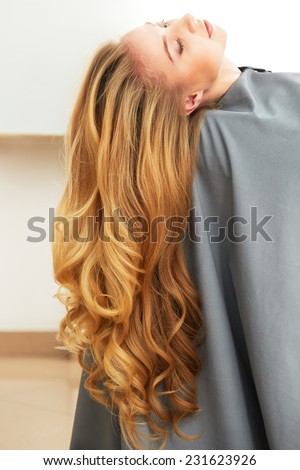 Blonde Hair. Woman in hair salon