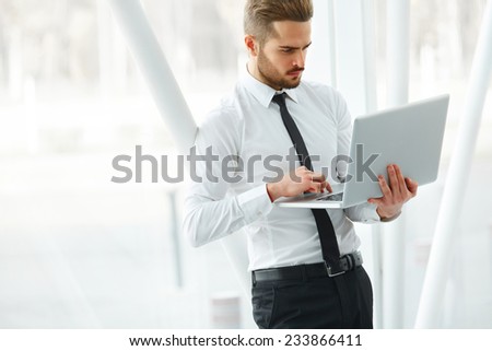 Businessman with laptop. Young Businessman Typing Something on Laptop