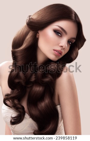 Hair. Portrait of Beautiful Woman with Long Wavy Hair. High quality image.