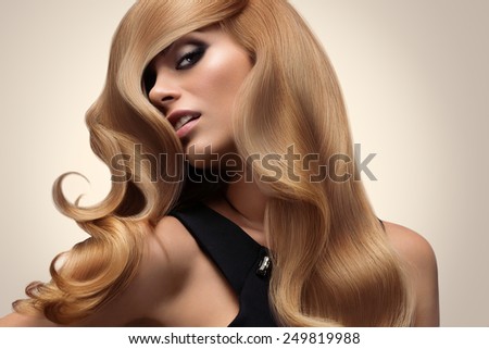Blond hair. Portrait of beautiful Blonde with Long Wavy Hair. High quality image.