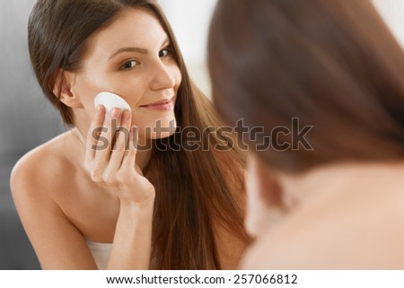 Spa Woman. Beautiful Woman Cleaning Her Face. Cosmetology and Make up. Skincare