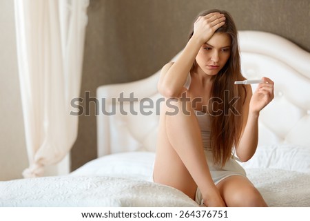 Pregnancy Test. Worried Woman Looking at a Test