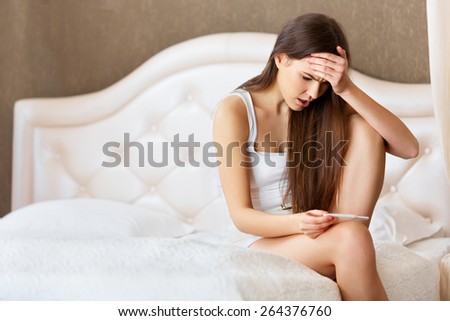 Pregnancy Test. Worried Woman Looking at a Test