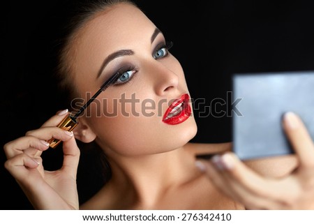 Make-up. Beautiful Woman Doing Makeup. Mascara Brush. Red Lips