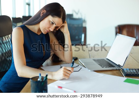 Stressed business woman at her working place. Business People