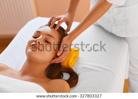 Face skin. Young woman receiving facial spa treatment. Masseur doing face massage with   refreshing, anti-aging cosmetics in renew beauty cosmetology esthetics medical spa salon or clinic.