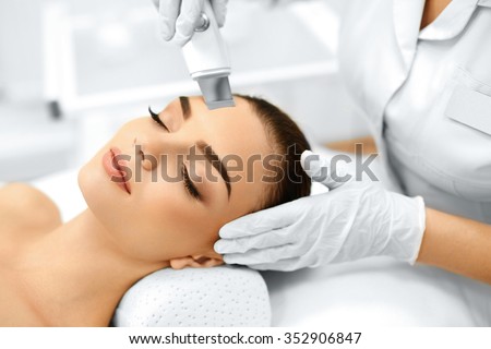 Skin Care. Close-up Of Beautiful Woman Receiving Ultrasound Cavitation Facial Peeling. Ultrasonic Skin Cleansing Procedure. Beauty Treatment. Cosmetology. Beauty Spa Salon.