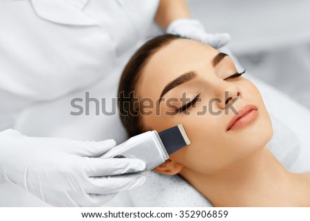 Skin Care. Close-up Of Beautiful Woman Receiving Ultrasound Cavitation Facial Peeling. Ultrasonic Skin Cleansing Procedure. Beauty Treatment. Cosmetology. Beauty Spa Salon.