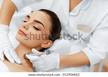 Face Skin Care. Closeup Of Beautiful Woman Getting Diamond Microdermabrasion Peeling Treatment In A Beauty Spa Salon. Cleansing Procedure. Cosmetology.