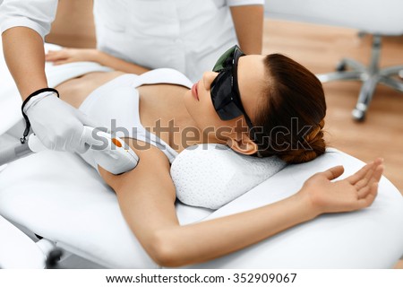Body Care. Underarm Laser Hair Removal. Beautician Removing Hair Of Young Woman\'s Armpit. Laser Epilation Treatment In Cosmetic Beauty Clinic. Hairless Smooth And Soft Skin. Health And Beauty Concept.