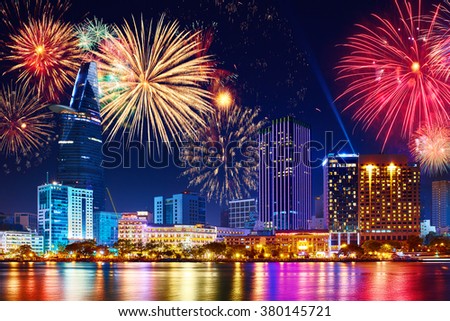 Celebration. Skyline with fireworks light up sky over business district in Ho Chi Minh City ( Saigon ), Vietnam. Beautiful night view cityscape. Holidays, celebrating New Year.