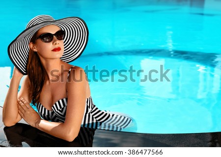 Beautiful Sexy Girl With Healthy Skin In Elegant Striped Bikini, Sun Hat Relaxing In Swimming Pool Water In Resort Spa Hotel On Travel Holidays Vacation.