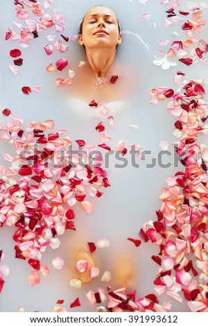 Spa Relax In Flower Bath. Woman Health And Beauty. Closeup Beautiful Sexy Girl Bathing With Rose Petals In Renew Day Spa Salon. Beauty Treatment, Aromatherapy Skin Body Care Therapy. Wellness Concept