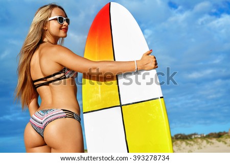 Fitness Girl. Extreme Summer Water Sports. Surfing. Healthy Fit Woman With Perfect Sexy Body And Butt, Buttocks In Bikini Posing With Surfboard On Ocean Beach. Vacations, Lifestyle, Beauty, Health