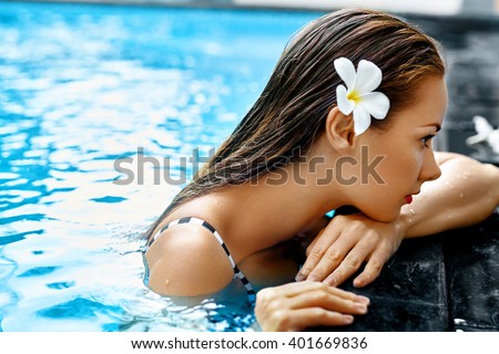Summer. Beautiful Sexy Young Woman, Girl With Healthy Skin In Bikini Relaxing In Swimming Pool Water In Resort Relax Spa Hotel. Holidays Vacation. Body Health Care, Beauty Concept. Lifestyle, Wellness