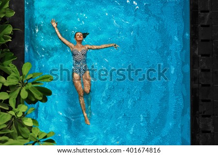 Woman In Pool Water. Beautiful Happy Girl With Sexy Fit Body Relaxing, Floating In Swimming Pool At Spa Hotel. Summer Holidays Vacation. Healthy Lifestyle. Wellness, Beauty, Health Concept. Recreation