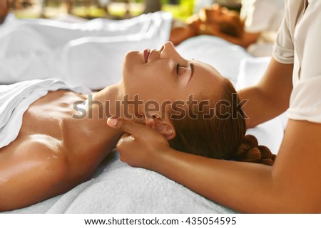 Spa Massage. Closeup Of Beautiful Healthy Happy Smiling Woman Getting Relaxing In Day Spa Salon Outdoors. Masseur Hand Massaging Neck With Aromatherapy Oil. Relax Body Care Beauty Treatment Concept
