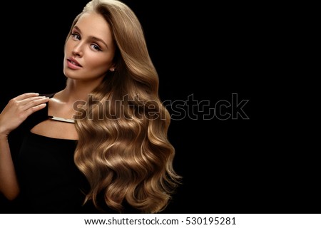 Hair Beauty And Makeup. Beautiful Fashion Girl Model With Perfect Blonde Hair Color And Gorgeous Face. Attractive Sexy Woman With Healthy Long Shiny Wavy Curly Hair Posing In Studio. High Resolution