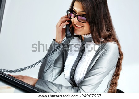 Cheerful business woman conversing on  phone