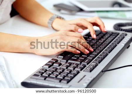 Closeup of business woman\'s hand typing on computer keyboard