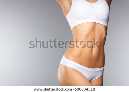 Body Care. Beautiful Woman In Shape With Fit Slim Body, Healthy Smooth Soft Skin In White Bikini Panties On Gray Background. Closeup Female Body In Underwear. Health And Diet Concepts. High Resolution