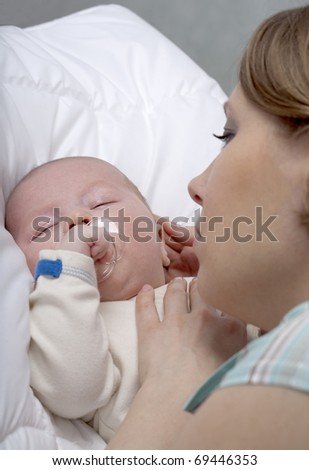 Closeup faces of happy mother with cute newborn baby