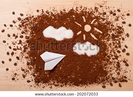 the coffee and paper airplane, top view. Travel concept