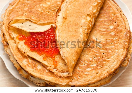 Pancake with red caviar. Traditional Russian cuisine