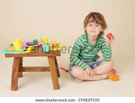Child, toddler boy, eating and playing with pretend food